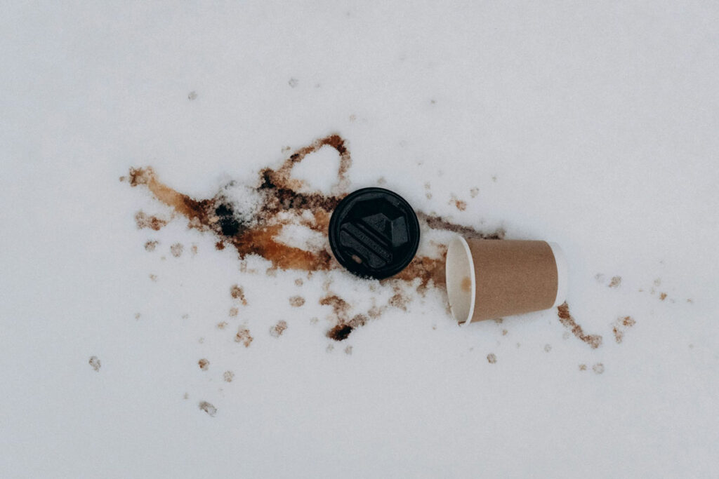coffee cup on the floor as a metaphor for quitting coffee to improve tinnitus